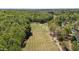 Scenic aerial view of a lush golf course surrounded by dense woodlands and clear blue skies at 720 Raymond Dr, Clayton, NC 27527