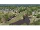 Picturesque aerial view of golf course homes, pond, and lush greenery under a bright sky at 720 Raymond Dr, Clayton, NC 27527