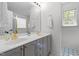 Bright bathroom featuring double sinks, a large mirror, and ample counter space at 720 Raymond Dr, Clayton, NC 27527