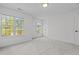 A bright bedroom featuring three windows, carpet and closet at 720 Raymond Dr, Clayton, NC 27527
