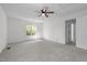 Spacious bedroom with neutral carpet, a ceiling fan, and a window for natural light at 720 Raymond Dr, Clayton, NC 27527