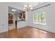 A dining room featuring a large window, chandelier, and hardwood floors at 720 Raymond Dr, Clayton, NC 27527