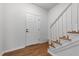 Bright entryway featuring hardwood floors, a white front door, and a staircase with white railings at 720 Raymond Dr, Clayton, NC 27527