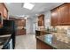 Well-equipped kitchen featuring granite countertops, stainless steel appliances, and wood cabinets at 720 Raymond Dr, Clayton, NC 27527