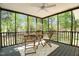A screened-in porch featuring a table and two chairs at 720 Raymond Dr, Clayton, NC 27527