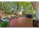 View of a back deck, with a metal railing, BBQ, bench, and landscaping at 730 N Harrison Ave, Cary, NC 27513