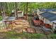 An aerial view of a backyard featuring a deck, sheds, and mature trees at 730 N Harrison Ave, Cary, NC 27513