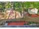 Aerial view of a backyard featuring a deck, sheds, a rock garden, and mature trees at 730 N Harrison Ave, Cary, NC 27513