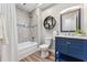 Contemporary bathroom with a blue vanity and sleek fixtures at 730 N Harrison Ave, Cary, NC 27513