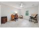Bright bedroom with a ceiling fan, a window, and furniture to allow for use as an office at 730 N Harrison Ave, Cary, NC 27513