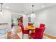 Bright dining area with hardwood flooring, a round table, and an open transition to the living area at 730 N Harrison Ave, Cary, NC 27513