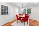 Cozy dining area with a round table, red chairs, and natural light from the windows at 730 N Harrison Ave, Cary, NC 27513