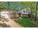 View of a two-story home's exterior, complete with a driveway and lush green front lawn at 730 N Harrison Ave, Cary, NC 27513