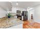 A kitchen featuring stone countertops, stainless steel appliances, and tile flooring at 730 N Harrison Ave, Cary, NC 27513