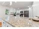 A kitchen featuring a stone countertop, stainless steel appliances, and white cabinetry at 730 N Harrison Ave, Cary, NC 27513