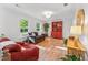Spacious living room with hardwood floors, large windows, and cozy furniture arrangement at 730 N Harrison Ave, Cary, NC 27513