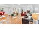 Open-concept living room with hardwood flooring, a staircase, and natural light from the windows at 730 N Harrison Ave, Cary, NC 27513