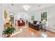 Bright living room with hardwood floors, comfortable seating, and staircase to the second floor at 730 N Harrison Ave, Cary, NC 27513
