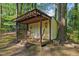 Backyard shed featuring a covered porch with rocking chairs for relaxing outdoors at 730 N Harrison Ave, Cary, NC 27513
