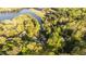 Aerial view of property backing up to lake with lush surrounding trees at 775 Sagamore Dr, Louisburg, NC 27549