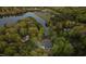 Aerial view of waterfront home with a private dock and mature trees in a tranquil, wooded setting at 775 Sagamore Dr, Louisburg, NC 27549