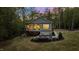 Charming backyard featuring a deck, patio with fire pit, and manicured lawn, perfect for outdoor gatherings at 775 Sagamore Dr, Louisburg, NC 27549