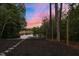 Scenic backyard with a lake view, a dock, and a charming stone pathway at 775 Sagamore Dr, Louisburg, NC 27549