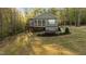 Landscaped backyard featuring patio with outdoor seating and a well-maintained lawn at 775 Sagamore Dr, Louisburg, NC 27549