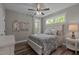 A calming bedroom features two bright windows, gorgeous floors, and charming wall decor at 775 Sagamore Dr, Louisburg, NC 27549