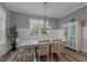 Dining room with table, chairs, cabinet, large window and light fixture at 775 Sagamore Dr, Louisburg, NC 27549