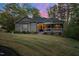 Single-Gathering home with stone-accented porch and manicured lawn, bathed in soft evening light at 775 Sagamore Dr, Louisburg, NC 27549