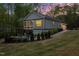 Stunning home with a deck, a patio with a fire pit, landscaping, and an attached garage at 775 Sagamore Dr, Louisburg, NC 27549