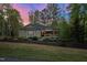 Well-maintained single-Gathering home with a manicured lawn and tasteful landscaping under a pastel sky at 775 Sagamore Dr, Louisburg, NC 27549