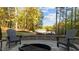 Cozy stone patio with outdoor seating and a fire pit overlooking tranquil waterfront views, ideal for relaxation at 775 Sagamore Dr, Louisburg, NC 27549