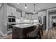 Modern kitchen features stainless steel appliances, light grey cabinets and island with bar seating at 775 Sagamore Dr, Louisburg, NC 27549
