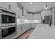 Bright kitchen featuring white cabinets, stainless steel appliances, and spacious countertops at 775 Sagamore Dr, Louisburg, NC 27549