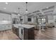 Open-concept kitchen with a large island, modern appliances, and seamless flow into the living area at 775 Sagamore Dr, Louisburg, NC 27549