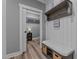 This mud room features a bench with storage and coat hooks, leading to the walk-in closet at 775 Sagamore Dr, Louisburg, NC 27549