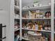 Walk-in pantry with shelving stocked with a variety of food and household items at 775 Sagamore Dr, Louisburg, NC 27549