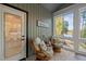 Screened in porch with lake views, two wicker chairs with cushions, and a sign at 775 Sagamore Dr, Louisburg, NC 27549