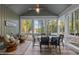 Sunroom with views of the water featuring ceiling fan, round table, and comfortable chairs at 775 Sagamore Dr, Louisburg, NC 27549