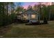 Charming home with a deck, patio, and a lush green lawn, creating an inviting outdoor space at 775 Sagamore Dr, Louisburg, NC 27549