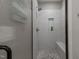 The clean shower features elegant tilework, built-in shelving, and a convenient bench at 775 Sagamore Dr, Louisburg, NC 27549