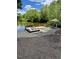 Beautiful view of the lake with a boat parked at a private dock and a peaceful seating area at 775 Sagamore Dr, Louisburg, NC 27549