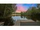 Scenic waterfront showcasing a wooden dock with swim ladder and a serene lake view, ideal for water activities at 775 Sagamore Dr, Louisburg, NC 27549