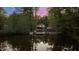 Waterfront home nestled among trees with a private dock and beautifully landscaped yard, offering peaceful lake living at 775 Sagamore Dr, Louisburg, NC 27549