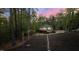 Landscaped pathway down to the lake with string lights and a private dock, perfect for peaceful evenings by the water at 775 Sagamore Dr, Louisburg, NC 27549