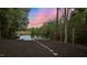 Picturesque waterfront view with a stone pathway leading to a private dock and seating area at 775 Sagamore Dr, Louisburg, NC 27549