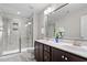 Bathroom features a double sink vanity, shower, and tile flooring at 7822 Allscott Way, Raleigh, NC 27612