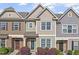 Charming townhome exterior with stone accents and a well-manicured front yard at 7822 Allscott Way, Raleigh, NC 27612